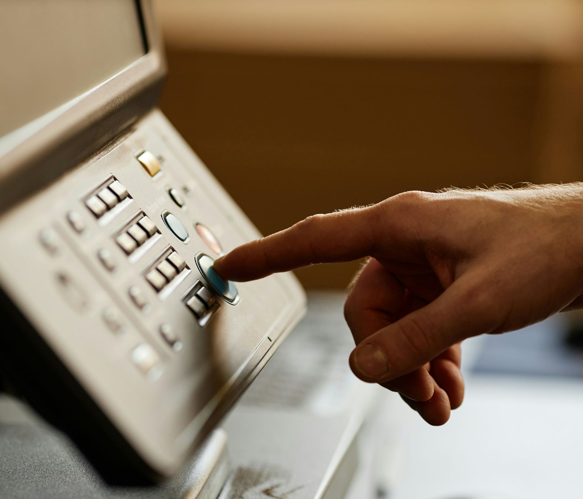 A modern multifunction printer producing a red document